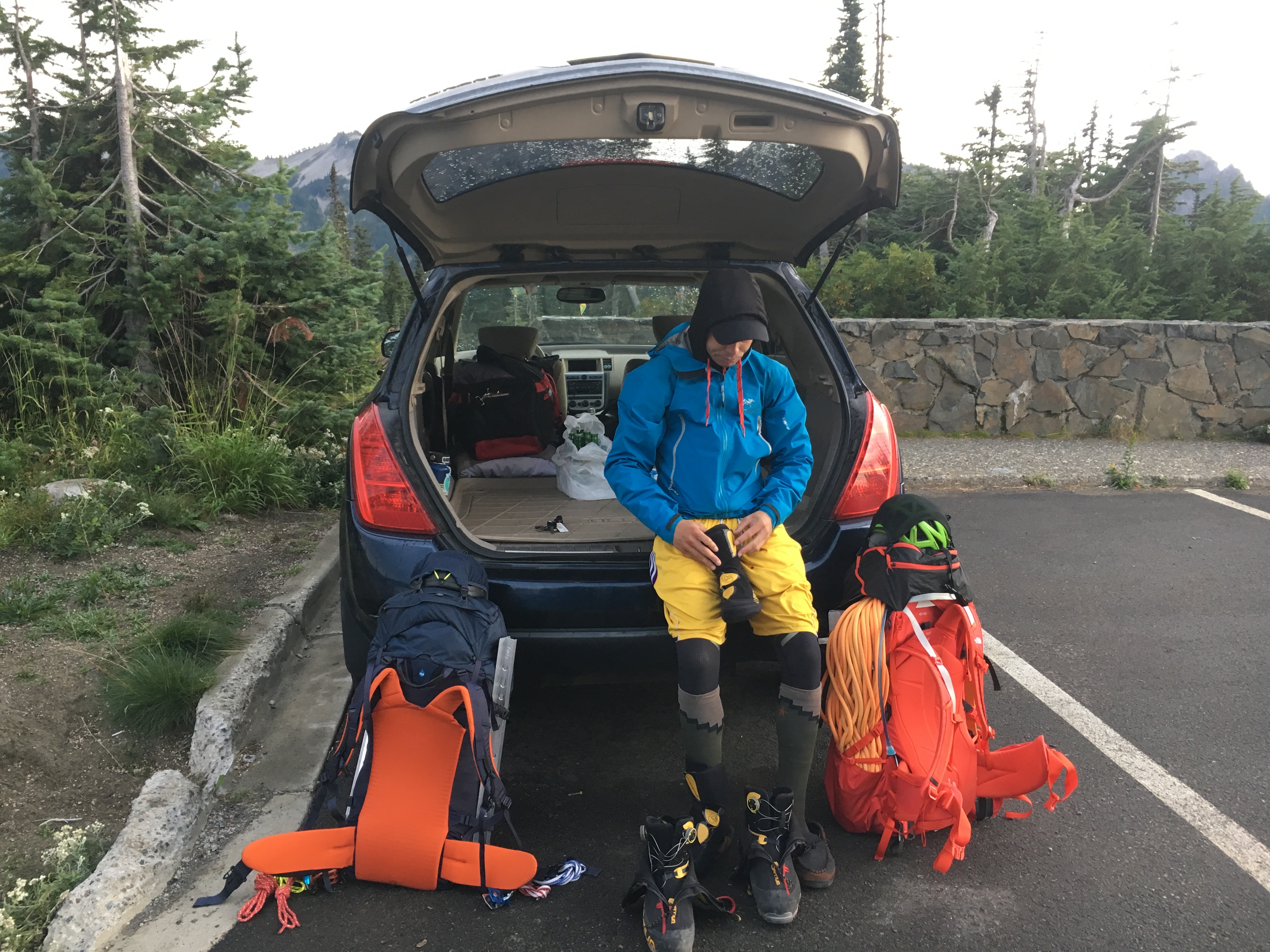 Ricky putting on his boots in preparation to climb Mount Rainier.