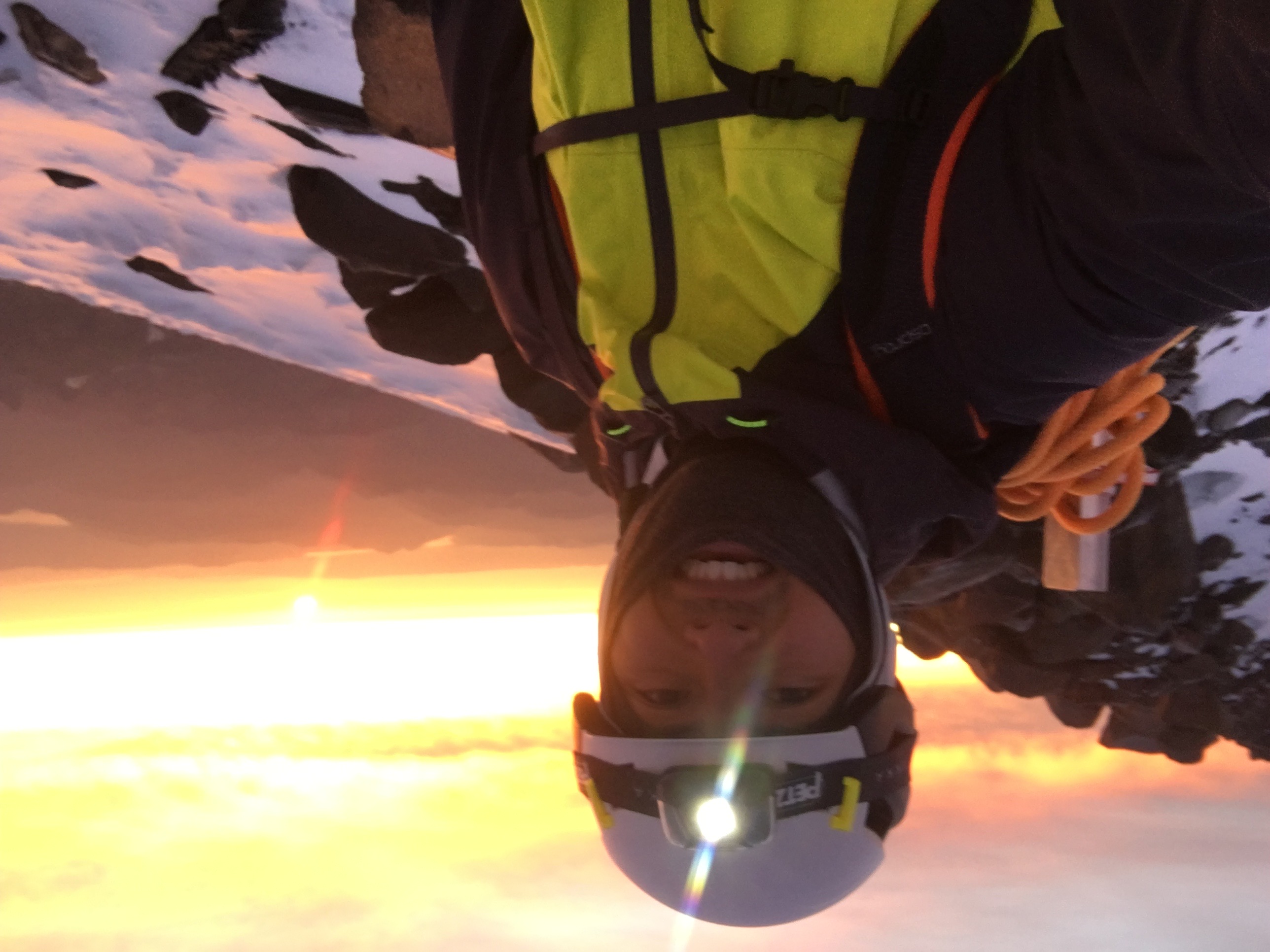 Yoshio at the Mount Rainier Southeast Crater Rim, with the sun rising behind him.
