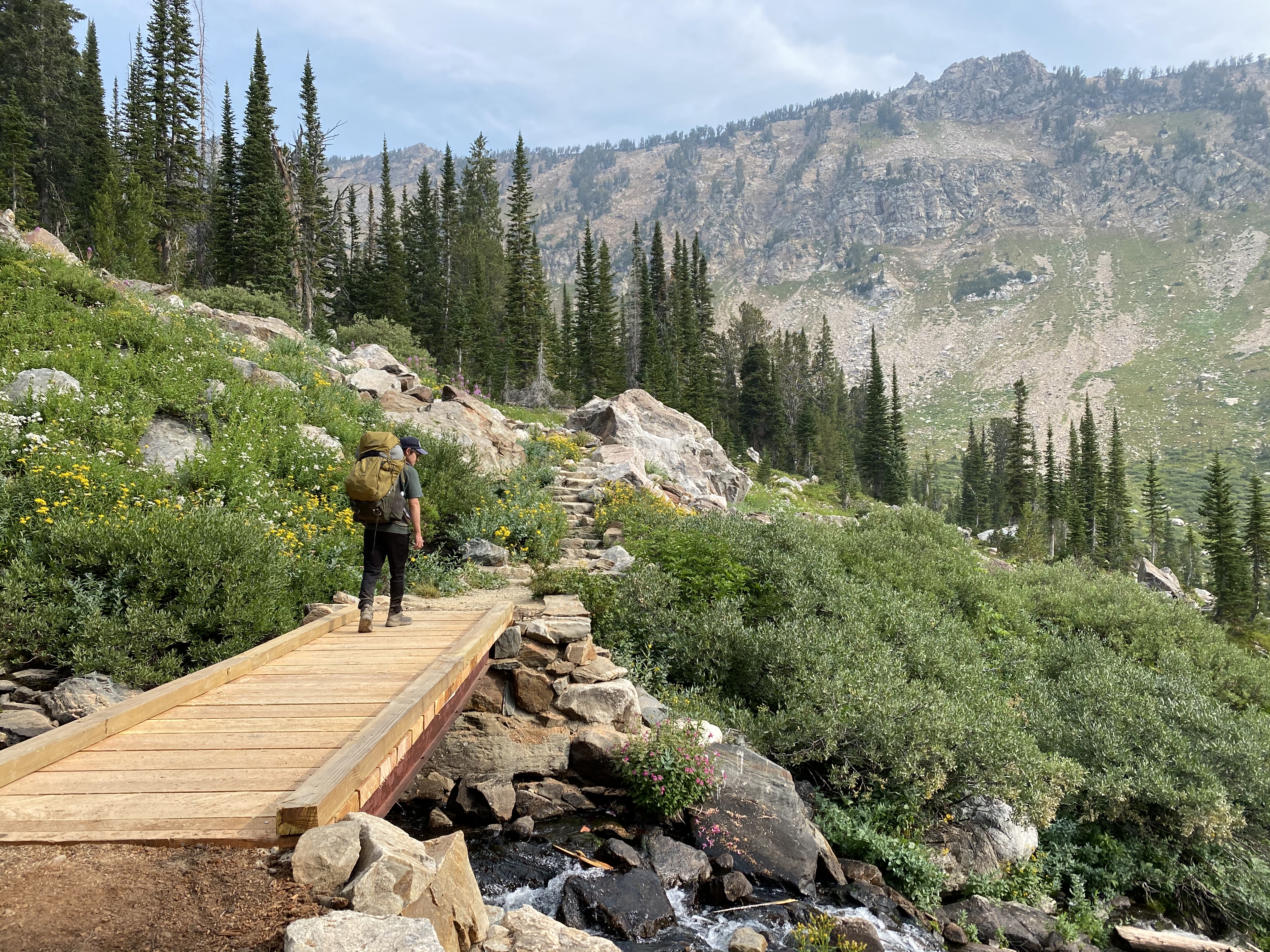 Timur hiking across a bridge.